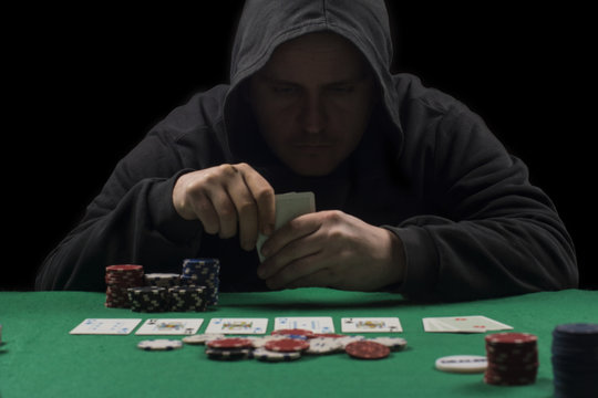 Poker table setup. High resolution image for gambling industry containning pokers chips, cards, green surface and person.