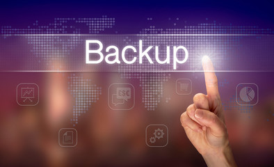 A hand selecting a Backup business concept on a clear screen with a colorful blurred background.
