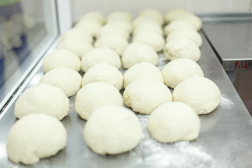 pieces of dough lying on a steel table top