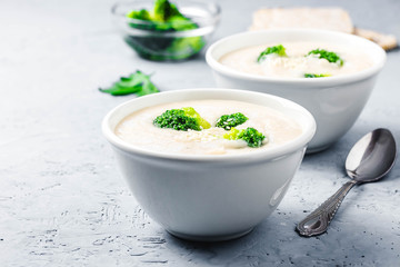 Garlic, parsnip white bean broccoli soup puree in a bowl on blue concrete background. Selective focus, space for text. 