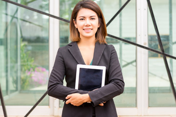 Businesswoman holding a tablet.