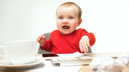 Happy child baby girl toddler sitting with keyboard of computer isolated on a white background