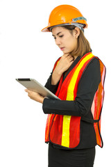Engineering woman stands holding and looking at the tablet over background is white.