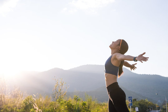 sport girl relaxing in summer sunset sky outdoor. People freedom style.