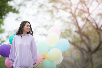 beautiful girl with balloons in park