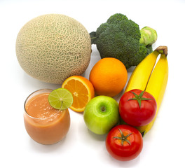 variety of colourful of organic fresh vegetable and fruit juices in a glass with green lemon isolated on white background
