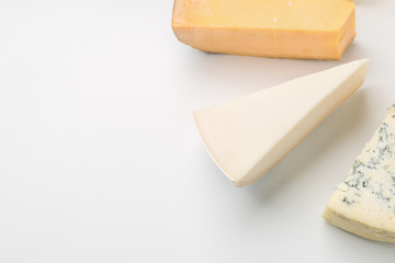 Different types of cheese on white background