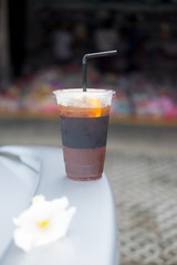 Iced black coffee with black straw