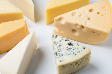 Different types of cheese on white background