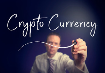 A businessman writing a Crypto Currency concept with a white pen on a clear screen.