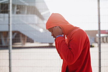 African American man puts on his earphones gwtting ready for jogging