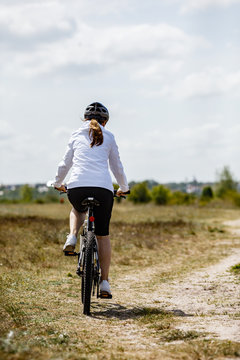 Middle-aged woman riding bicycle