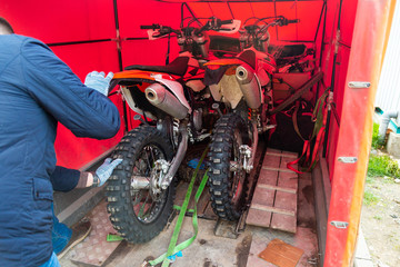 mechanic fixing motorcycle wheel