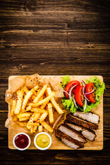 Grilled beefsteak with french fries and vegetables