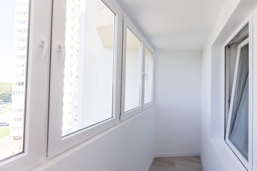 White metal-plastic windows of balcony in modern apartment