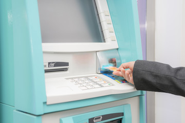 Woman hand used ATM card or credit card for withdraw money from ATM machine.