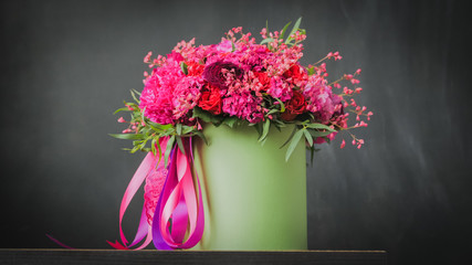 Beautiful wedding bouquet in green box on the black background. Floristry and handmade concept