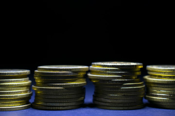 Golden coins with black empty space on top.