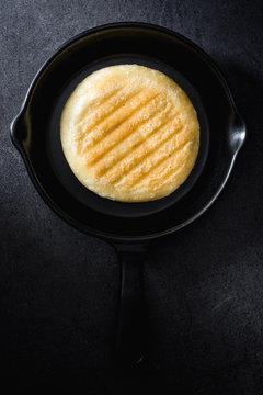 Food lying on black frying pan