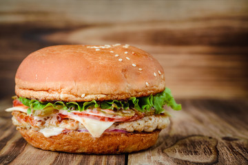 Appetizing homemade burger on a wooden background