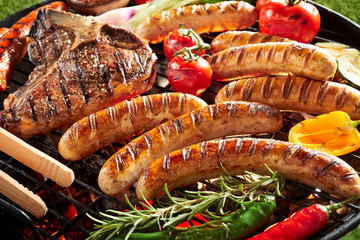 Outdoor summer barbecue with meat on a grill - obrazy, fototapety, plakaty