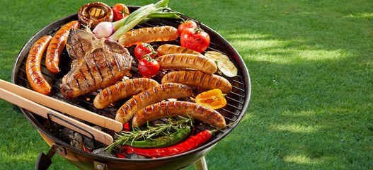 Meat and vegetables grilling on an outdoor BBQ - obrazy, fototapety, plakaty