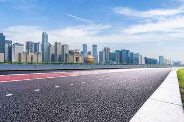 Fototapeta na wymiar panoramic cityskyline with empty road