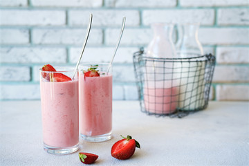 Strawberry smoothies with yogurt or milk. Spring or summer cocktail in glass on white background
