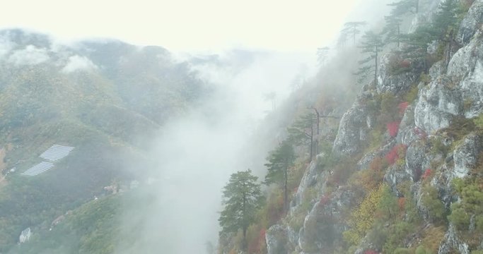Aerial shot of mountain through clouds - Transylvania mountains