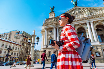 tourist woman with photo camera in the middle of european city