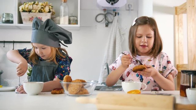 Group of children decorating cookies with jam