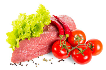 Piece of fresh veal, lettuce leaves, tomatoes and pepper isolated on white