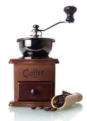 Manual coffee grinder with a box for ground powder, near scoop with coffee beans, isolated on white