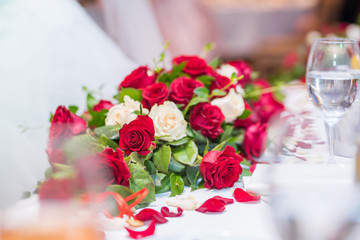 Red and white roses decoration for a table. Wedding decoration