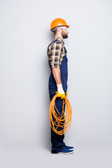 Full size fullbody snap, side view half face portrait of attractive calm electrician with bristle...