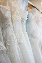 Fototapeta na wymiar white wedding dresses hanging on racks