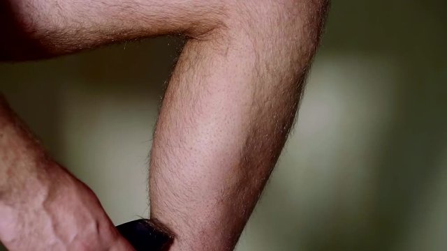 shaving machine men's hairy legs part of the lower leg