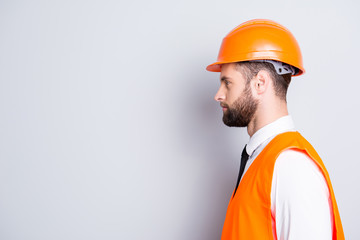 Profile portrait with copy space, empty place for advertisement of handsome calm man in hard hat...
