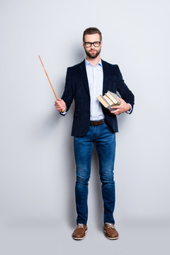 Full Size Fullbody Portrait Of Clever Smart Teacher In Shirt, Jacket, Jeans With Stubble Having Three Books And Pointer In Arms, Looking At Camera Isolated On Grey Background