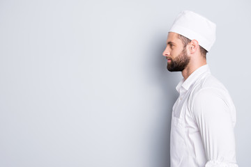 Profile side view portrait with copyspace, empty place for advertisement of attractive handsome butcher standing over grey background