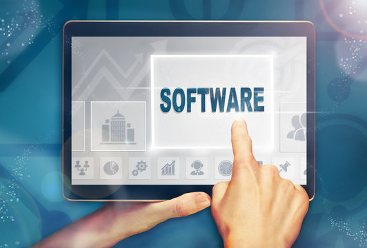A hand selecting a Software business concept on a computer tablet screen with a colorful background.