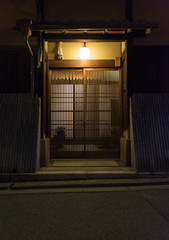 Naklejka premium Traditional Japanese house at night, entrance door