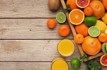 Variety of ripe citruses on wooden background