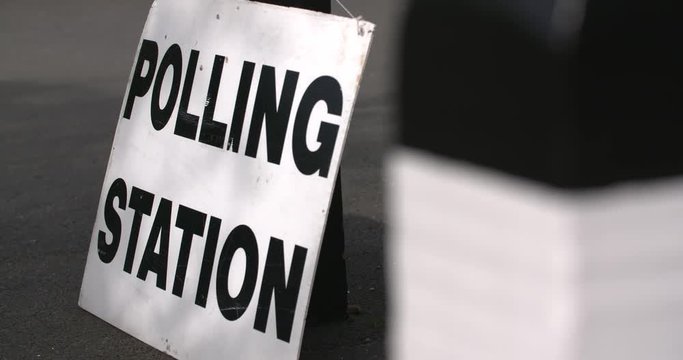 4k slow motion focus pull to polling station sign on election day