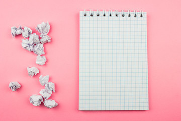  Crumpled white paper balls and notepad. Empty space for text and design
