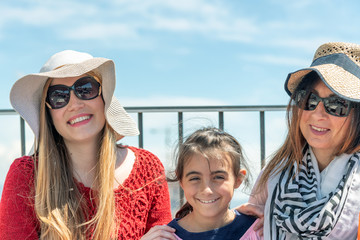 Three generations women on a city rooftop enjoying outdoor life. Tourism and holiday concept