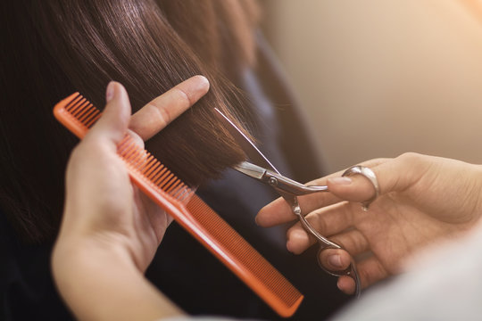 Cropped Shot Of Female Client Receiving A Haircut