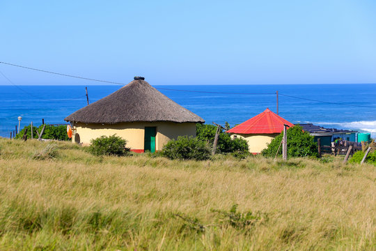 Rondawel, traditional thatched roofed hut near Coffee Bay on the Wild Coast in Eastern Cape, South Africa, with a view over the Indian Ocean