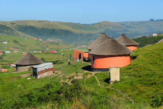 Rondawels, traditional thatched-roofed huts scattered through the grassy hills in a village near Coffee Bay on the Wild Coast in Eastern Cape, South Africa