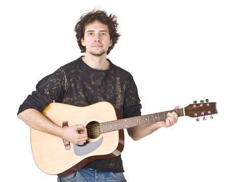 Young guy playing on a gitare and posing to camera